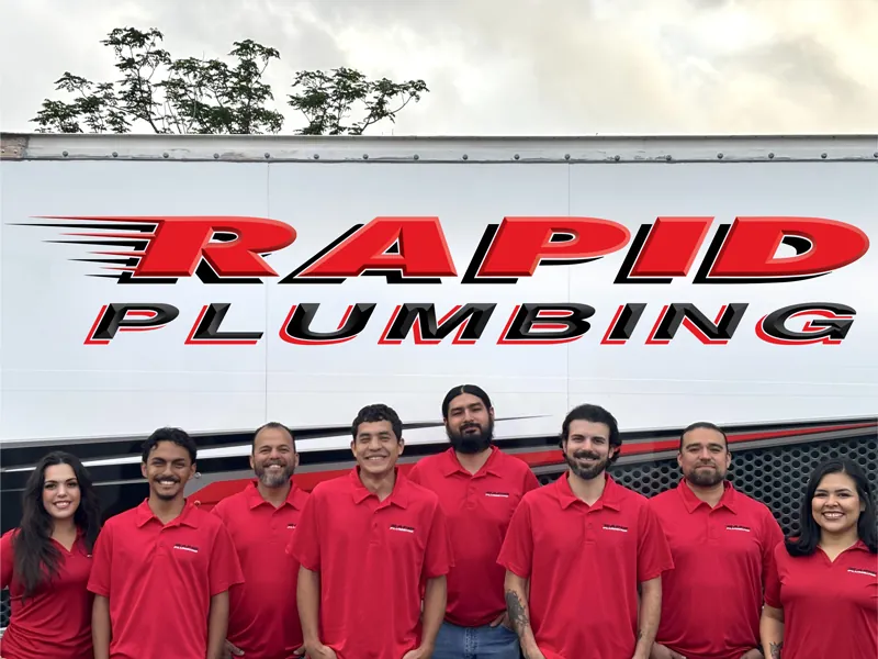 Rapid Plumbing team members in red company polos