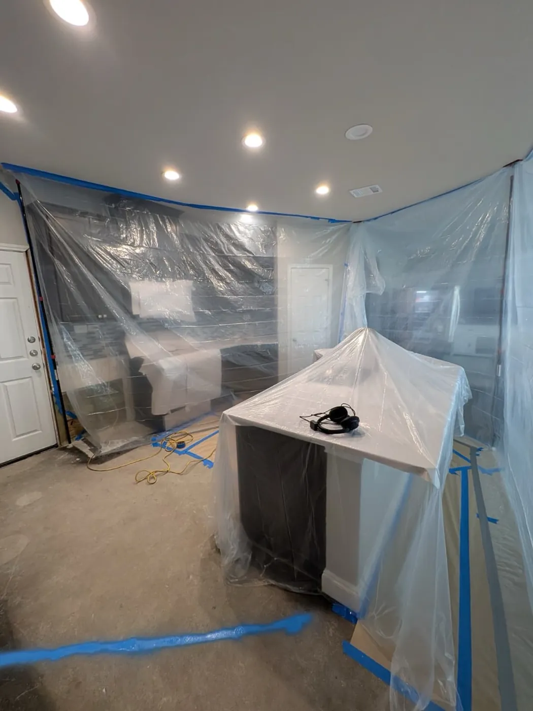 Interior plumbing job with dust containment protecting the home